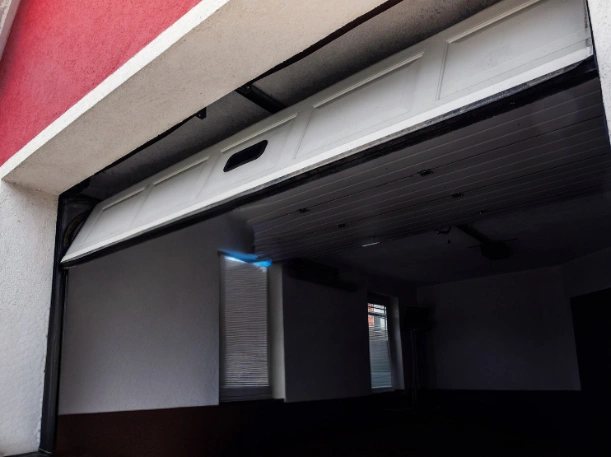Detailed look at the interior panels and high-quality hinges of a residential overhead door during a professional installation.