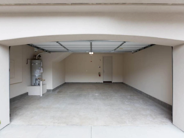 Custom garage door track installation in Greer, SC, designed to fit arched residential garage openings for a seamless interior finish.