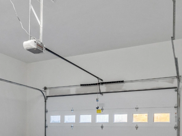 Professional installation of a LiftMaster belt-drive garage door opener with a heavy-duty torsion spring system by Greer Garage Doors.