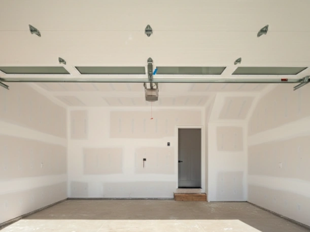 Interior view of a professional garage door opener installation on a white sectional door with clear glass window panels by Greer Garage Doors.